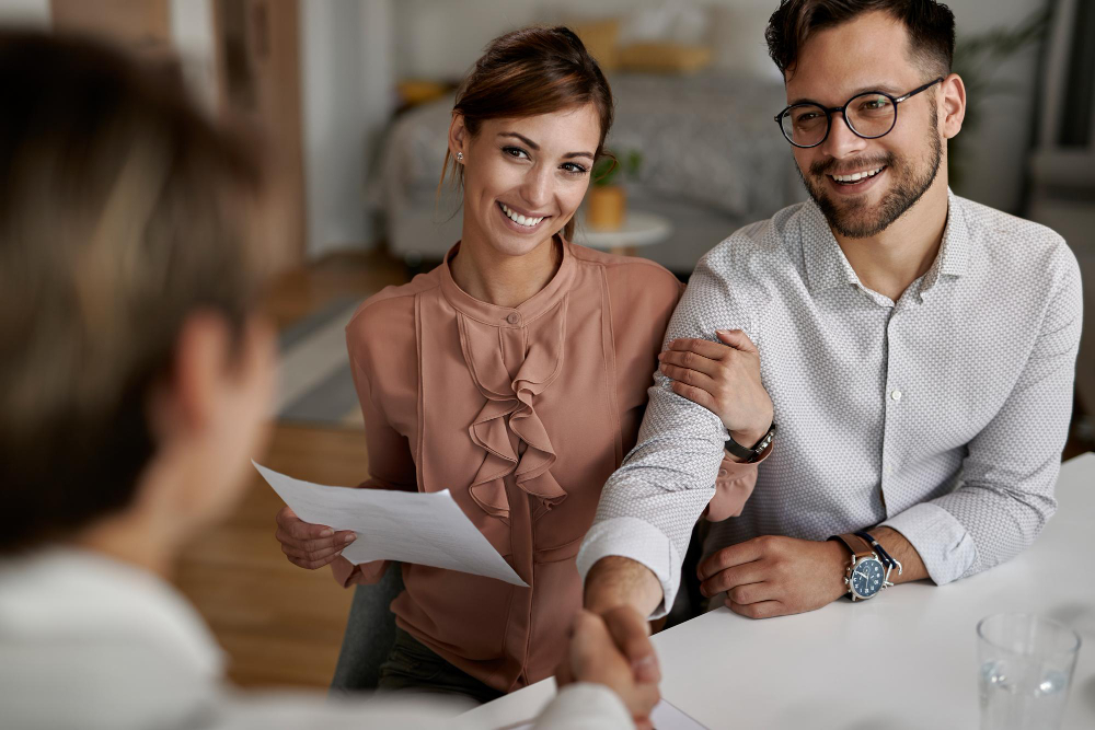 Couple signing rental contract with landlord